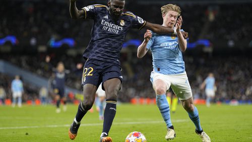 Manchester City's Kevin De Bruyne, right, fights for the ball with Real Madrid's Antonio Rudiger during the Champions League quarterfinal second leg soccer match between Manchester City and Real Madrid at the Etihad Stadium in Manchester, England, Wednesday, April 17, 2024. (AP Photo/Dave Shopland)