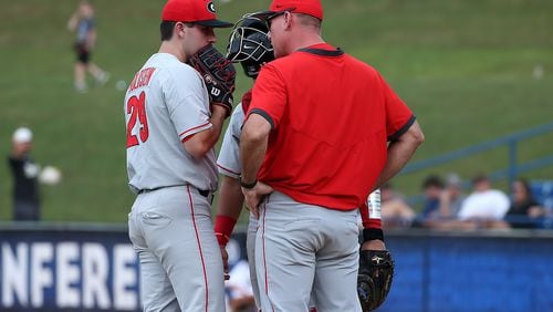 Georgia pitcher Charlie Goldstein (29) confers with pitching coach Sean Kenny and catcher Fernando Gonzalez early during the Bulldogs' game against No. 1 Arkansas in the SEC Tournament in Hoover, Ala., on Wednesday, May 26, 2021. (Photo by Michael Wade/SEC)
