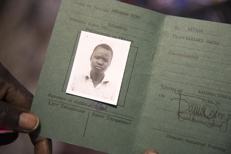 The only photo that Abraham Deng Ater has of himself as a young boy is a trade school certificate of completion for carpentry, displayed at his residence in Snellville. He says he thinks he may have been around 15 to 17 years old. Like many of the Lost Boys, Ater does not know how old he is. ALYSSA POINTER / ALYSSA.POINTER@AJC.COM