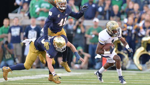 September 19, 2015 South Bend, Indiana - Georgia Tech Yellow Jackets running back Qua Searcy (1) eludes a tackle by Notre Dame Fighting Irish linebacker Joe Schmidt (38) and Notre Dame Fighting Irish cornerback Matthias Farley (41) in the second half at Notre Dame Stadium in South Bend, Indiana on Saturday, September 19, 2015. Georgia Tech Yellow Jackets lost the game 30-22. HYOSUB SHIN / HSHIN@AJC.COM