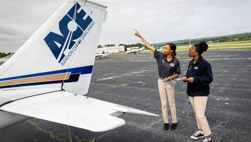 Aviation Career Enrichment Academy flight instructor Ashley Moss (Left) performs a preflight check on a Cessna 172 with student pilot Kelsey Griffin, 15, before their flight at Brown Field In Atlanta. (Steve Schaefer / AJC)