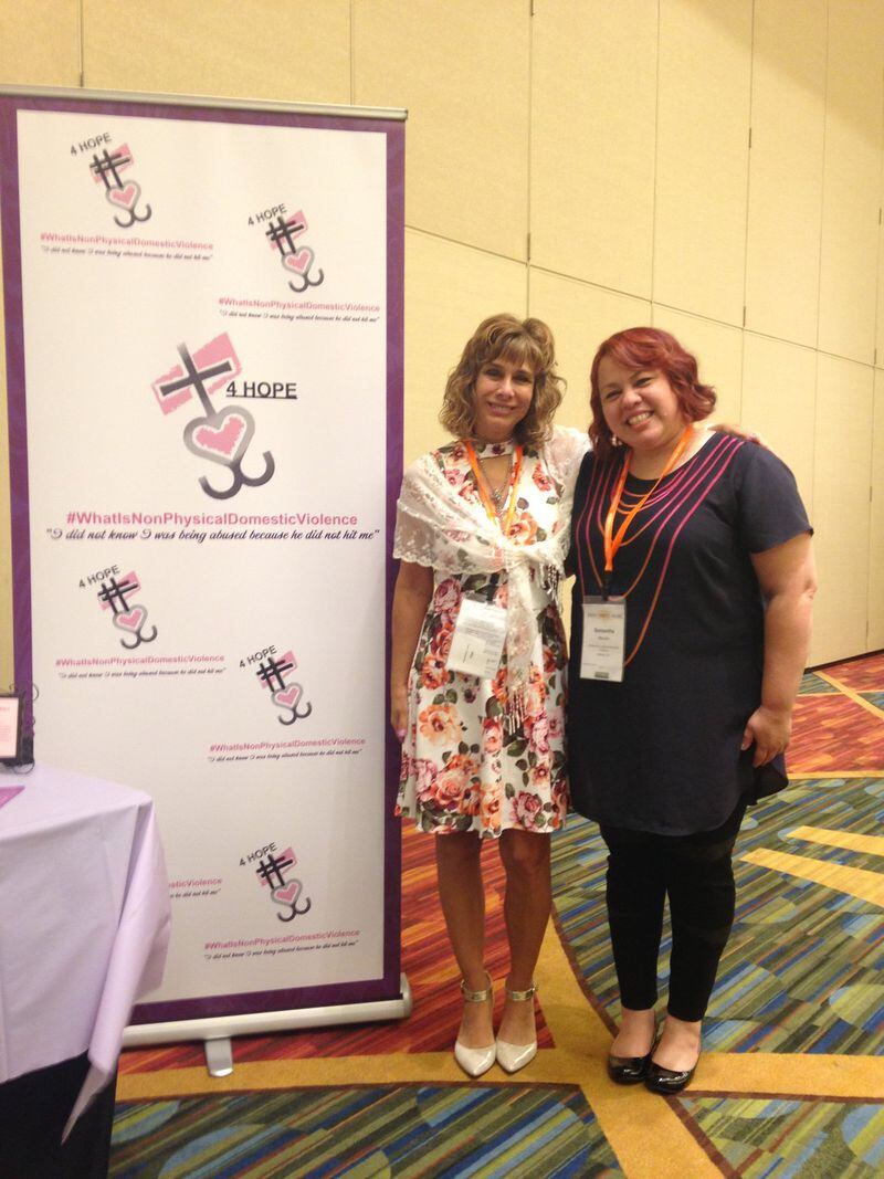 Angie Racine (left) with a participant at the National Conference on Health And Domestic Violence last month in Atlanta. “I did not know I was being abused because he did not hit me,” she said. CONTRIBUTED
