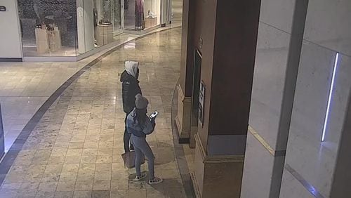Security camera footage from Phipps Plaza shows a couple who police believe were involved in a shooting at the theater there.