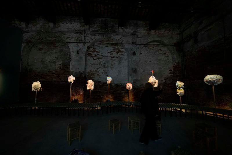 Visitors look the installation ' A Dance With Her Myth' by artist Mounira Al Solh at the Lebanese pavilion of the 60th Biennale of Arts exhibition in Venice, Italy, Tuesday, April 16, 2024.The Venice Biennale contemporary art exhibition opens Saturday for its six-month run through Nov. 26. The main show titled 'Stranieri Ovunque – Foreigners Everywhere' is curated for the first time by a Latin American, Brazilian Adrian Pedrosa. Pedrosa is putting a focus on underrepresented artists from the global south, along with gay and Indigenous artists. Alongside the main exhibition, 88 national pavilions fan out from the traditional venue in Venice's Giardini, to the Arsenale and other locations scattered throughout the lagoon city. (AP Photo/Luca Bruno)