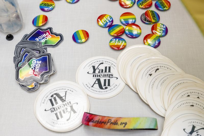 An assortments of stickers and pins were made available on a table for participants in the LGBTQ protest Monday at Georgia Southern University. (AJC Photo/Katelyn Myrick)