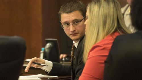 Joseph Rosenbaum (center) speaks with his wife Jennifer (right) during their trial in front of Henry County Chief Judge Brian Amero at the Henry County Superior courthouse, Thursday, July 11, 2019.