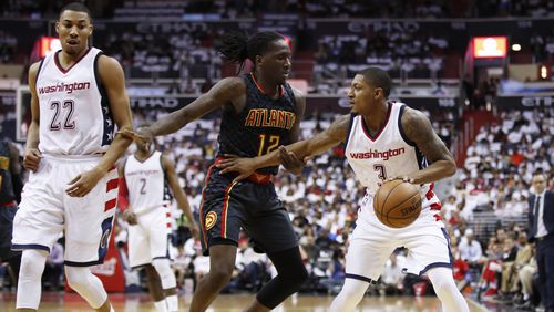 Washington Wizards guard Bradley Beal (3) is guarded by Atlanta Hawks forward Taurean Prince (12) during the first half in Game 1 of a first-round NBA basketball playoff series, in Washington, Sunday, April 16, 2017. (AP Photo/Manuel Balce Ceneta)