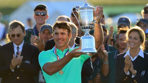 Brooks Koepka power-lifts the U.S. Open trophy Sunday in Wisconsin. (Richard Heathcote/Getty Images)