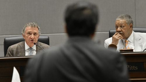 July 14, 2021 Atlanta - Commissioner Lee Morris (left) questions Michel “Marty” Turpeau IV (foreground), chairman of DAFC, as Commission Chairman Robb Pitts (right) looks during a meeting at the Fulton County government building in Atlanta on Wednesday, July 14, 2021. Michel “Marty” Turpeau IV, chairman of the embattled Development Authority of Fulton County (DAFC), announced Monday he will end his dual role as interim executive director, effective Aug. 31. (Hyosub Shin / Hyosub.Shin@ajc.com)