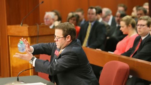 Feg. 12, 2015 - Atlanta - Rep. Jay Roberts catches a bottled water tossed to him before presenting a revised House plan to raise $1 billion for transportation to the full Transportation Committee. House Bill 170 has also garnered new critics as the Sierra Club denounced its lack of funding for transit and it's creation of a new user fee on electric vehicle drivers while a Washington think-tank and a Republican House member unveiled a study that showed eliminating a state tax credit for the purchase of electric vehicles would cost the state more than $200 million in lost GDP over the next 16 years. BOB ANDRES / BANDRES@AJC.COM Rep. Jay Roberts catches a bottled water tossed to him before presenting a revised House plan to raise $1 billion for transportation to the full Transportation Committee. Bob Andres, bandres@ajc.com