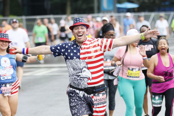 Runners make their way up Peachtree Street during the 54th running of the Atlanta Journal-Constitution Peachtree Road Race in Atlanta on Tuesday, July 4th, 2023.   (Miguel Martinez / Miguel.MartinezJimenez@ajc.com)