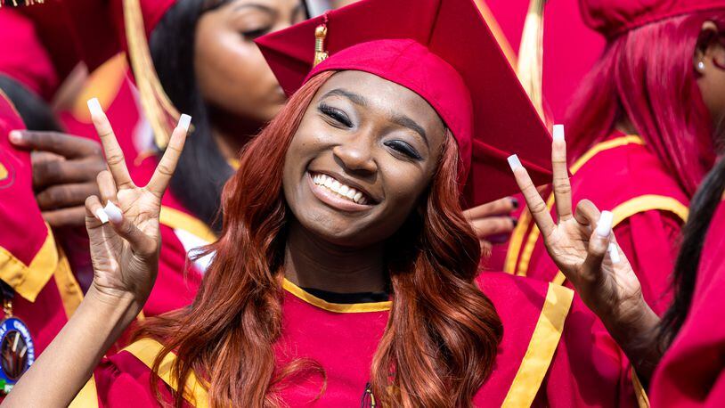 Janiyah Gibson, a member of Creekside High School’s Tribe Academy, poses for a photo while standing with Creekside students before their graduation ceremony at Gateway Arena in College Park on Thursday, May 18, 2023. (Arvin Temkar / arvin.temkar@ajc.com)