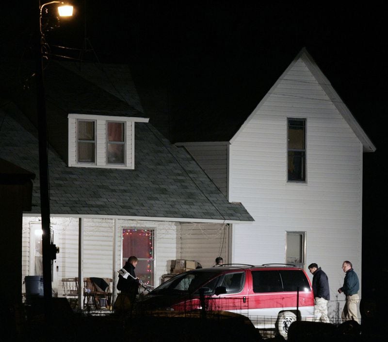 Police investigators search outside the home of Lisa and Kevin Montgomery in Melvern, Kansas, on Dec. 17, 2004. Lisa M. Montgomery was convicted in the kidnapping of an 8-month-old fetus and the killing of the mother, Bobbie Jo Stinnett. (Joe Ledford/The Kansas City Star/TNS)