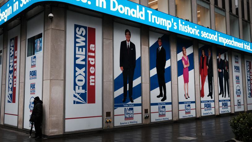 News headlines on the impeachment trial of Donald Trump are displayed outside of the Fox headquarters on Feb. 9, 2021, in New York. (Spencer Platt/Getty Images/TNS)