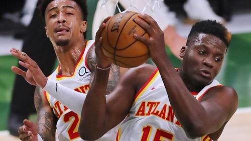 Hawks defenders John Collins and Clint Capela (right) go up for the rebound against the Milwaukee Bucks in Game 1 of the Eastern Conference Finals Wednesday, June 23, 2021, at Fiserv Forum in Milwaukee. (Curtis Compton / Curtis.Compton@ajc.com)