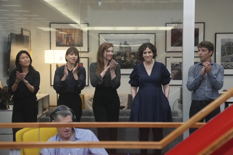Hannah Dreier, second from right, as colleagues applaud during a Pulitzer Prize gathering in the newsroom of The New York Times in New York, Monday, May 6, 2024. Dreier won a Pulitzer in investigative reporting for her stories on migrant child labor across the United States. (Hiroko Masuike/The New York Times via AP)