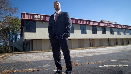 Joshua Butler stands in front of a building he owned before the Great Recession near Fulton County Airport. He says losses totaled $250,000. Monday, Nov. 24, 2018.