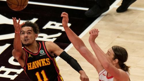 Hawks guard Trae Young (11) shoots as Houston Rockets forward Kelly Olynyk (41) rushes in to try to block during the first half Sunday, May 16, 2021, at State Farm Arena in Atlanta. The Hawks won the regular season finale 124-95. (Ben Gray/AP)