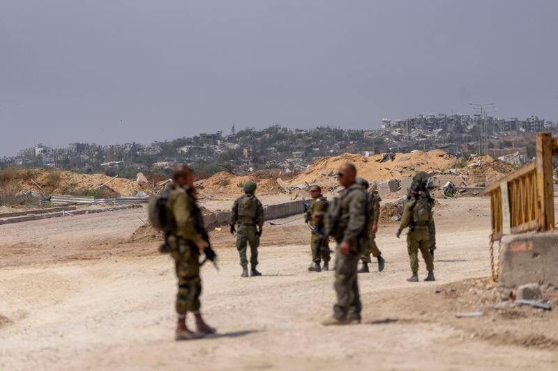 Israeli soldiers gather on the Israeli side of the Erez crossing from southern Israel into Gaza, bordering a battle-ravaged area of the northern Gaza Strip, Wednesday, May 1, 2024. (AP Photo/Ohad Zwigenberg)