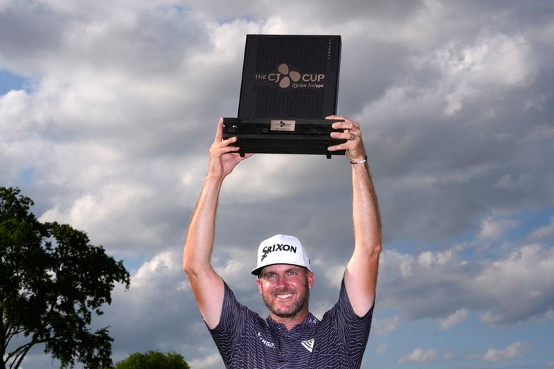 Taylor Pendrith holds up the champion's trophy after winning the Byron Nelson golf tournament in McKinney, Texas, Sunday, May 5, 2024. (AP Photo/LM Otero)