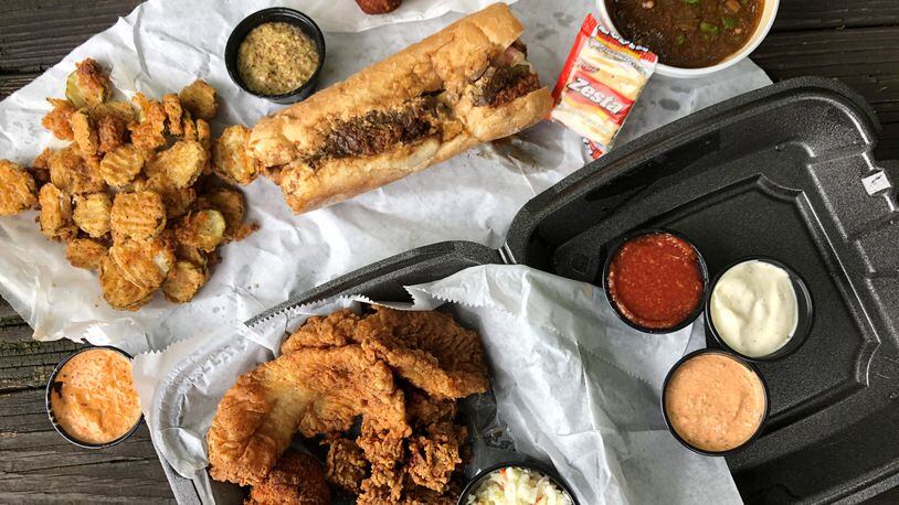A feast from the Po’Boy Shop in Decatur (clockwise from left): fried pickles, boudin balls, gumbo, a combo platter with fried oysters, grouper, hush puppies and slaw, and a  po’boy with fried shrimp, roast beef and its debris). CONTRIBUTED BY WENDELL BROCK