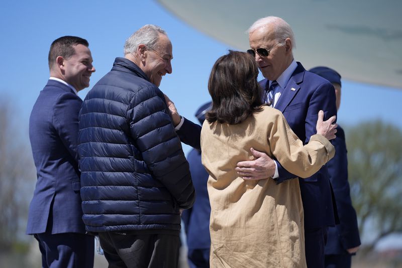 President Joe Biden, from right, is greeted by New York Gov. Kathy Hochul, Senate Majority Leader Chuck Schumer, D-N.Y., and Syracuse Mayor Ben Walsh, as he arrives at Hancock Field Air National Guard Base, Thursday, April 25, 2024, in Syracuse, N.Y. (AP Photo/Evan Vucci)