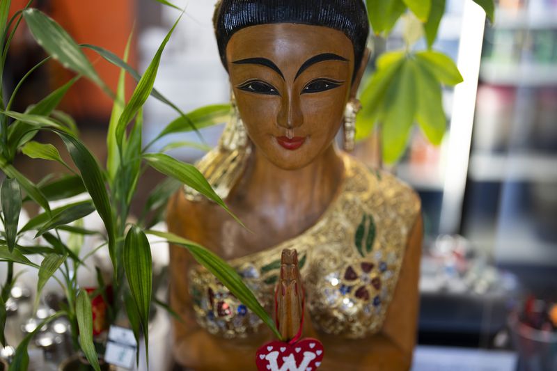 A statue is seen at Chiang Rai Thai Cuisine, a family restaurant run by members of the Iu Mien community, on Tuesday, April 30, 2024, in Troutdale, Ore. There is a sizeable Iu Mien community in Portland and its suburbs, with a Buddhist temple and Baptist church, active social organization, and businesses and restaurants. (AP Photo/Jenny Kane)