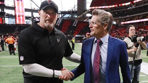 Falcons general manager Thomas Dimitroff  (right) congratulates head coach Dan Quinn on a 40-14 victory over the Cardinals in mid-December.