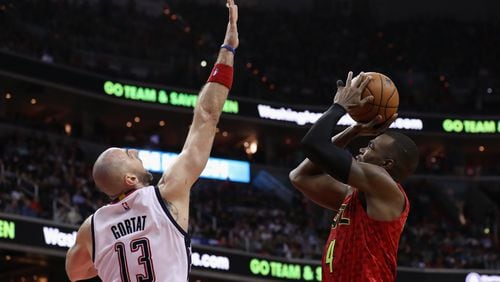 Paul Millsap of the Atlanta Hawks puts up a shot in front of Marcin Gortat of the Washington Wizards in the second half in Game 5 of the Eastern Conference quarterfinals at Verizon Center on April 26, 2017 in Washington, DC. (Photo by Rob Carr/Getty Images)