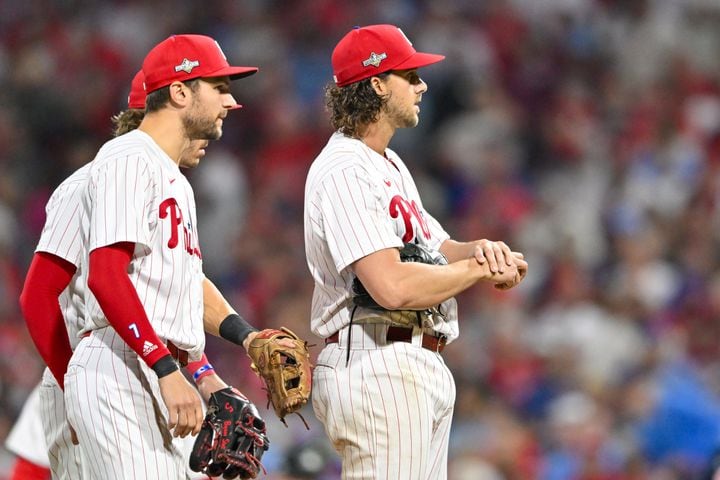 Philadelphia Phillies starting pitcher Aaron Nola, right, is relieved during the sixth inning of NLDS Game 3 against the Atlanta Braves in Philadelphia on Wednesday, Oct. 11, 2023.   (Hyosub Shin / Hyosub.Shin@ajc.com)
