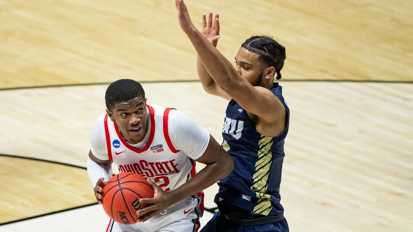 Ohio State's E.J. Liddell, left, gets pressure from Oral Roberts' Kevin Obanor during the first half of a First Round game in the NCAA men's college basketball tournament, Friday, March 19, 2021, at Mackey Arena in West Lafayette, Ind. (AP Photo/Robert Franklin)