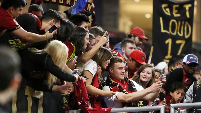 Atlanta United midfielder Julian Gressel takes selfies with fans, he was name best player of the match after scoring a goal and one assistance against LAFC April 7, 2018, at Mercedes-Benz Stadium in Atlanta.