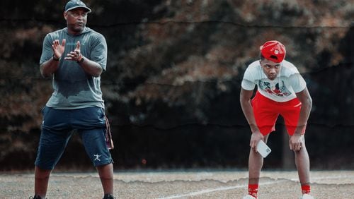 iDareU Academy founder and CEO Glenn Ford (L) works with Creekside defensive back Daiqun White at a camp last summer. Ford, a UGA football letterman, interviewed for the Bulldogs' defensive backfield coaching vacancy on Thursday. (Special Photo)