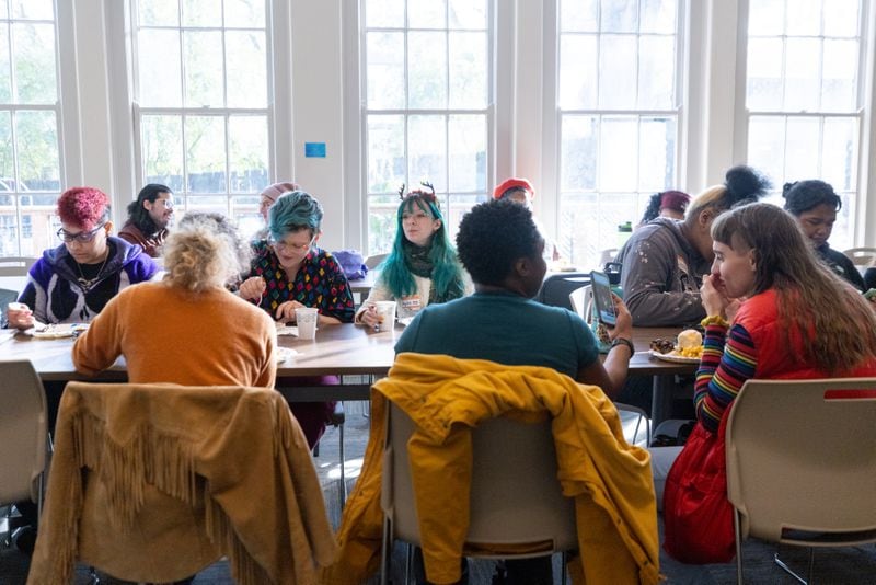 Attendees share a meal at a Friendsgiving Potluck hosted by Southern Fried Queer Pride at Neighborhood Church in Atlanta, GA, on Sunday, November 20, 2022.(Photo/Jenn Finch)