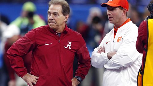 FILE - In this Jan. 1, 2018, file photo, Alabama head coach Nick Saban, left, and Clemson head coach Dabo Swinney talk before the Sugar Bowl semifinal playoff game for the NCAA college football national championship in New Orleans. Swinney and the Tigers play in their third national championship game in four seasons next Monday, Jan. 7, 2019, against top-ranked Alabama.  (AP Photo/Gerald Herbert, File)