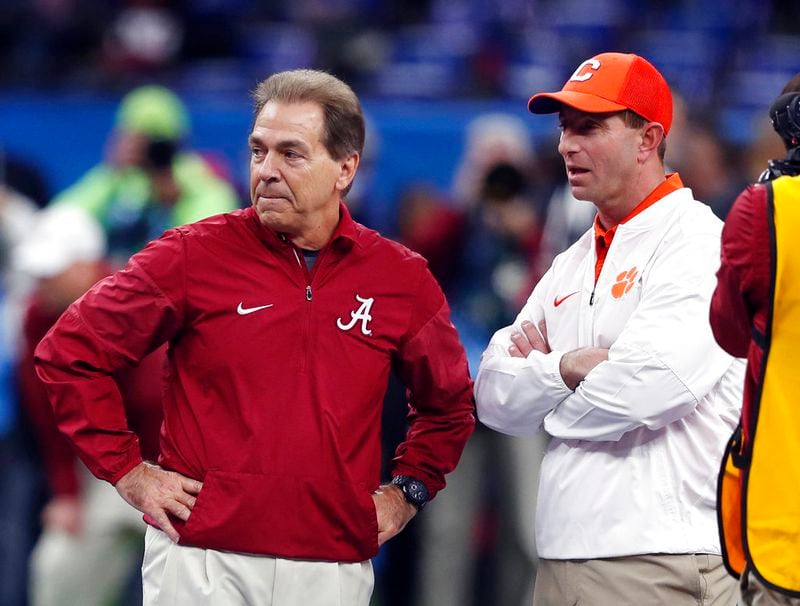 FILE - In this Jan. 1, 2018, file photo, Alabama head coach Nick Saban, left, and Clemson head coach Dabo Swinney talk before the Sugar Bowl semifinal playoff game for the NCAA college football national championship in New Orleans. Swinney and the Tigers play in their third national championship game in four seasons next Monday, Jan. 7, 2019, against top-ranked Alabama.  (AP Photo/Gerald Herbert, File)