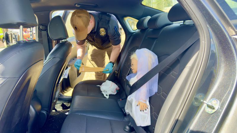 A Bride of Chucky doll buckled into the back seat in a car driven by a South Georgia woman. At a license checkpoint off I-16 in Twiggs County last weekend, the woman was ticketed for not wearing her own seat belt (Joe Kovac Jr / joe.kovac@ajc.com)