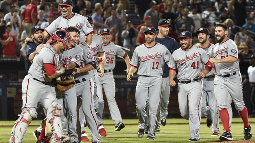 The Nationals celebrated winning the NL East title Tuesday night at Turner Field, the latest indignation for the skidding Braves.