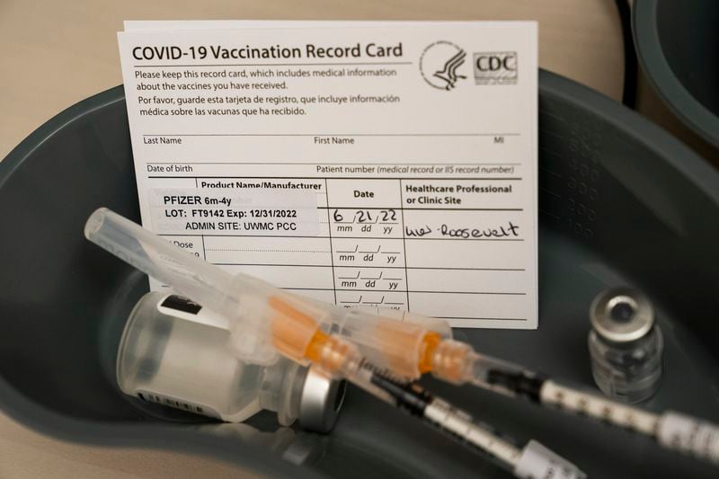 Doses of the Pfizer COVID-19 vaccine and vaccination record cards await patients at UW Medical Center - Roosevelt on June 21, 2022, in Seattle. (David Ryder/Getty Images/TNS)
