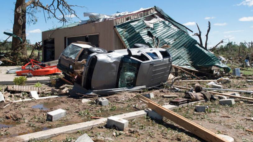 An overturned vehicle rests on the ground surrounded by debris in Canton, Texas, Sunday, April 30, 2017 after tornadoes hit the area the previous night. Severe storms including tornadoes swept through several small towns in East Texas, killing several people, and leaving a trail of overturned vehicles, mangled trees and damaged homes, authorities said Sunday. (Sarah A. Miller/Tyler Morning Telegraph)