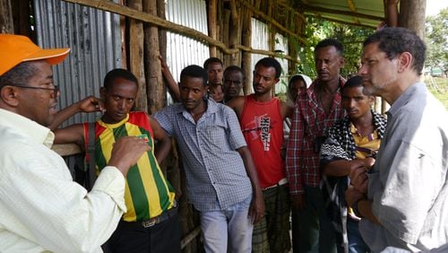 Dr. Frank Richards, on the right, in Ethiopia in 2013 talks to villagers about river blindness. Richards leads a Carter Center campaign to eradicate the disease. The Carter Center reports a large region is showing signs of having succeeded in eliminating new cases.