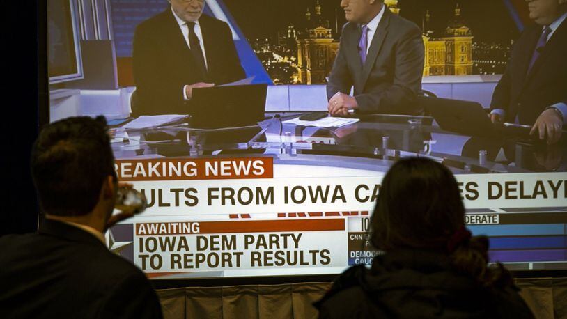 Supporters of Sen. Amy Klobuchar (D-Minn.) watch television news coverage of the Iowa caucuses during a caucus night party in Des Moines on Monday night, Feb. 3, 2020. Unexplained “inconsistencies” in Iowa caucus results, heated conference calls and firm denials of hacking left the contest in a strange state of almost suspended animation. (Pete Marovich/The New York Times)
