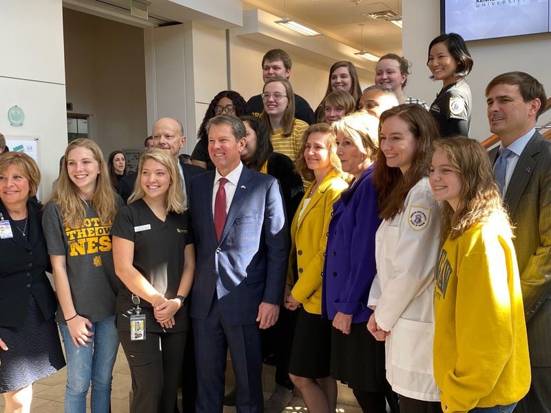 Georgia Gov. Brian Kemp (center in the front row) is joined by Kennesaw State University students and other officials after an announcement by Wellstar Health System that it is donating $8.7 million to the university's nursing program. 