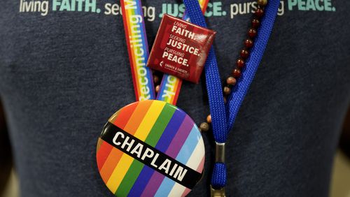 A convention goer wears a button supporting LGBTQ clergy at the United Methodist Church General Conference  in Charlotte, N.C. United Methodist delegates repealed their church’s longstanding ban on LGBTQ clergy with no debate on Wednesday, removing a rule forbidding “self-avowed practicing homosexuals” from being ordained or appointed as ministers. (AP Photo/Chris Carlson)