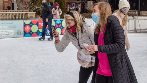 Avalon on Ice in Alpharetta is busy with friends Leslie Neslage (left) and Mary Allison Chapman, whose 4-year-olds are best friends, while posing for a photo Sunday, January 17, 2021. (Jenni Girtman for The Atlanta Journal-Constitution)
