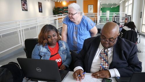 Student Destiny Glass, 18, works with special education teacher Ladonna Crowder (standing) during her study time at the Graduation Achievement Charter High School learning center Tuesday, April 22, 2018, in Atlanta.  PHOTO / JASON GETZ
