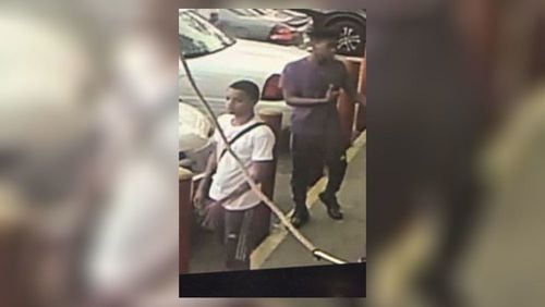 This surveillance photo shows the two persons of interest in connection with a shooting death. (Credit: Fulton County Police Department)