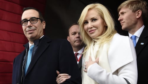 In this Friday, Jan. 20, 2017, file photo, then Treasury Secretary-designate Stephen Mnuchin and his then-fiancee, Louise Linton, arrive on Capitol Hill in Washington, for the presidential inauguration of Donald Trump. Linton responded to a social media critic on Aug. 21, 2017, telling the mother of three that that she was "adorably out of touch." Mnuchin and Linton were married in June. (Saul Loeb/Pool Photo via AP, File)