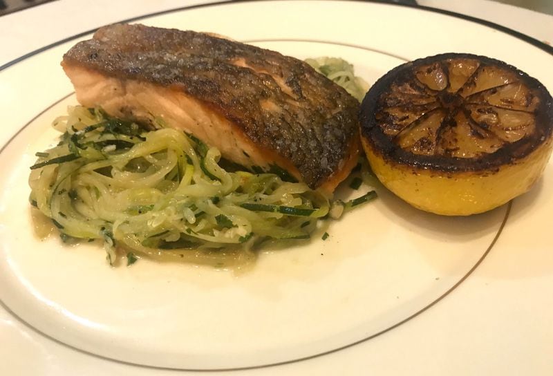 Pan-roasted salmon from Aix sits on a bed of sauteed, spiralized zucchini. LIGAYA FIGUERAS / LIGAYA.FIGUERAS@AJC.COM