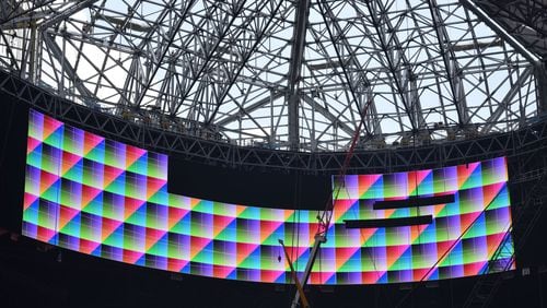 The halo board around the opening of Mercedes-Benz Stadium’s retractable roof show some test images during a media tour Thursday. HYOSUB SHIN / HSHIN@AJC.COM
